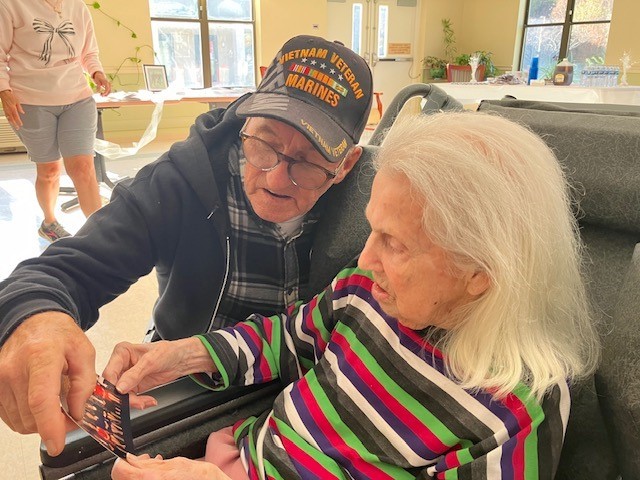 Betty M. and her son, Bob, reminisce over family photographs.