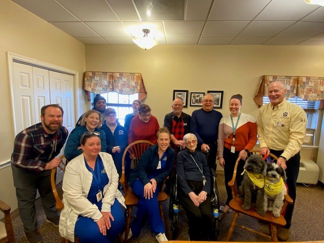 Evie H surrounded by friends and family