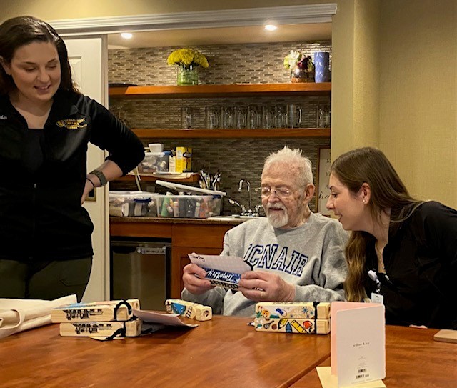 Grayson M looking at a wooden train whistle