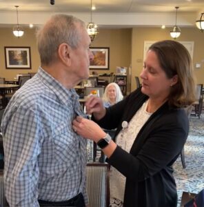 Veteran receiving a pin from Lifesong staff