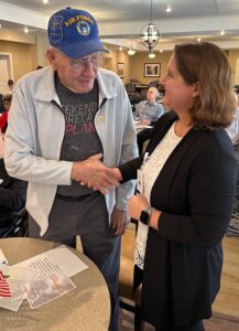 Air Force veteran shaking hands with Lifesong staff